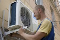 Мастер проводит установку кондиционера